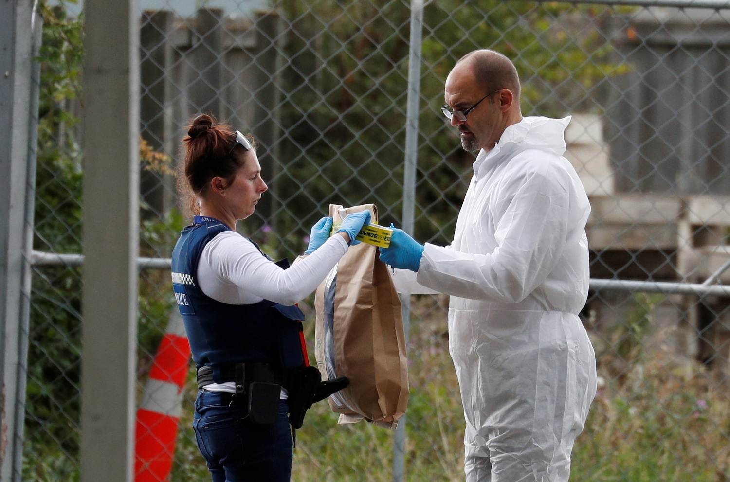 محققون وأفراد شرطة يجمعون أدلة من محيط مسجد النور بعد هجوم إرهابي في نيوزيلندا، 16 مارس 2019. رويترز 