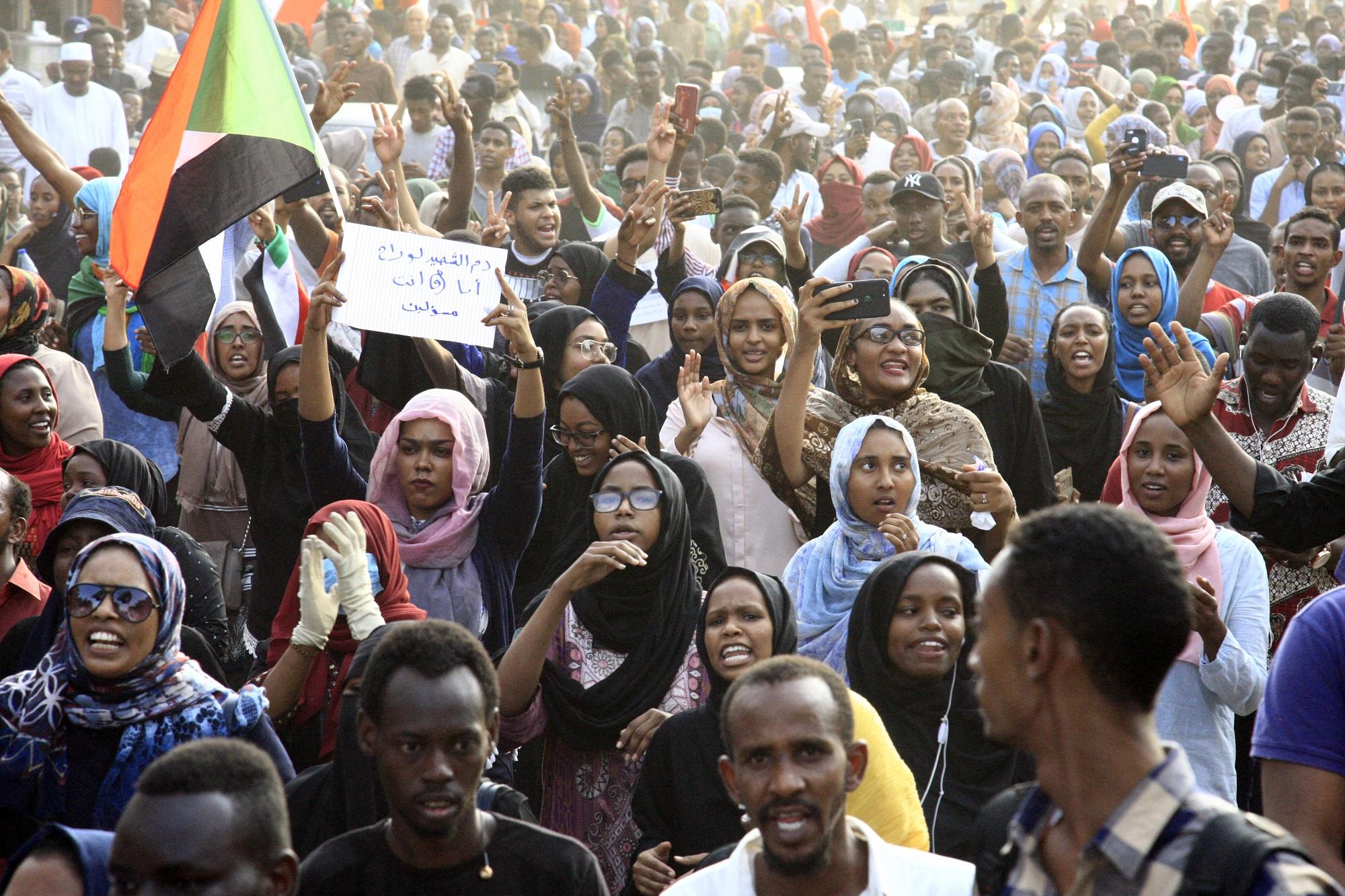 سودانيون وسودانيات خلال مسيرة في الخرطوم لتأبين ضحايا فض دام لاعتصام الشهر الماضي. (أ ف ب)