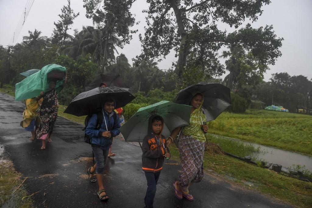 يحمل قرويون أمتعتهم في طريقهم لدخول مركز إغاثة، بينما يقترب إعصار بلبل في ولاية البنغال الغربية الهندية. 9 نوفمبر 2019. (أ ف ب )