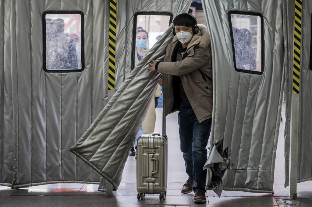 مسافر يرتدي قناعًا في محطة سكة حديد بكين الغربية في بكين .24 يناير 2020. نيكولاس عصفوري / أ ف ب