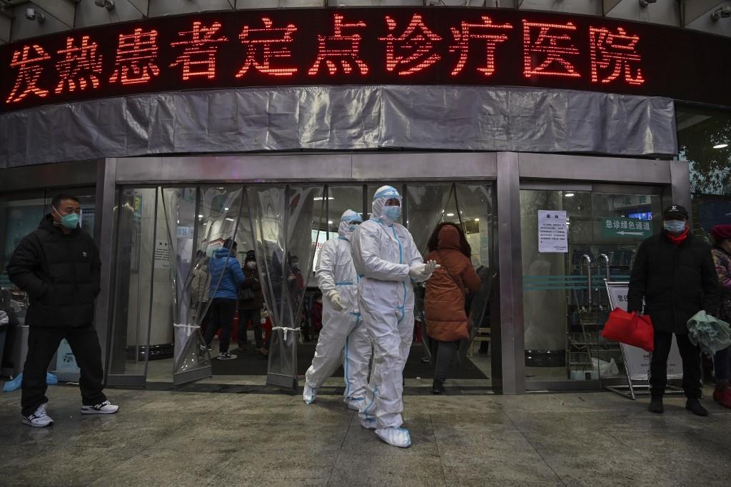 أعضاء في الفريق الطبي الصيني يمشون في مستشفى الصليب الأحمر في مدينة ووهان الصينية. 25 يناير 2020.هيكتور ريتامال / أ ف ب 