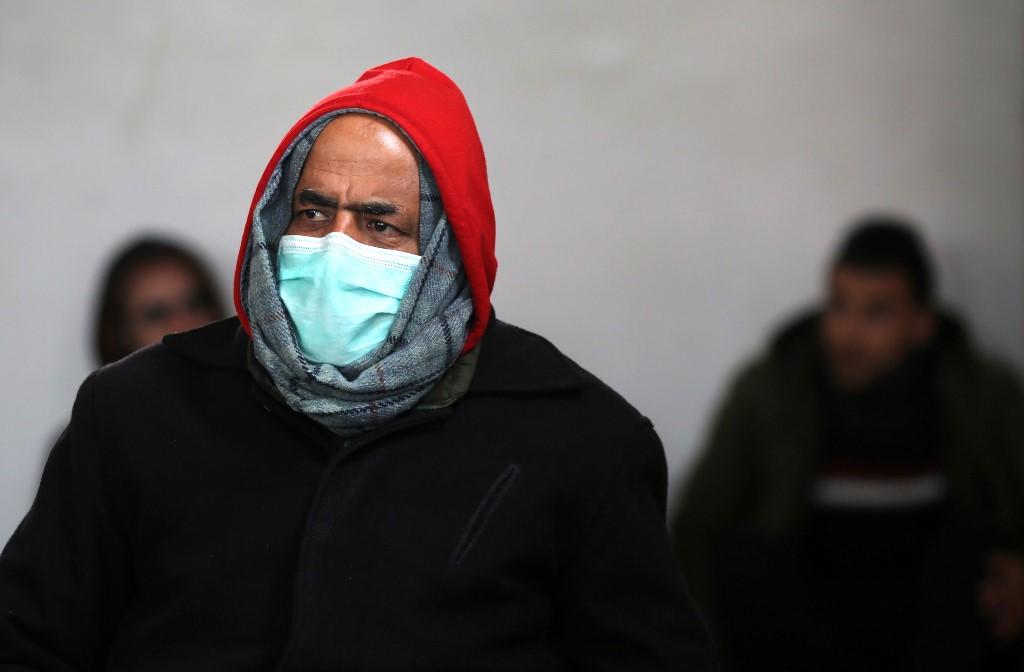 فلسطيني يرتدي قناعًا مؤقتًا كإجراء وقائي ضد الفيروس التاجي COVID-19 خلال جلوسه لصلاة الجمعة في مسجد في بلدة رفح جنوب قطاع غزة ، 20 مارس ، 2020. (سعيد خطيب / أ ف ب)