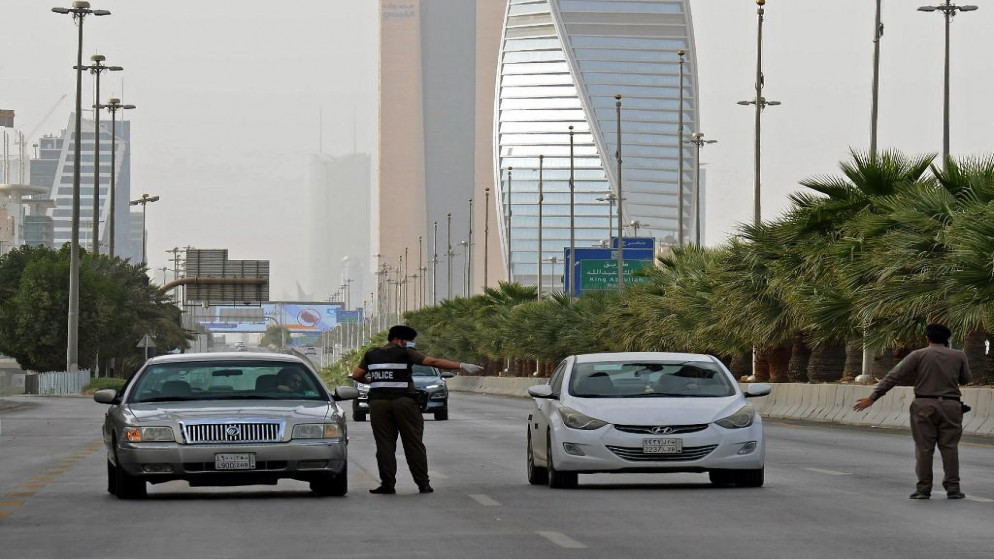 رجال شرطة سعوديون عند نقطة تفتيش على طريق الملك فهد في العاصمة الرياض.(فايز نور الدين / أ ف ب)