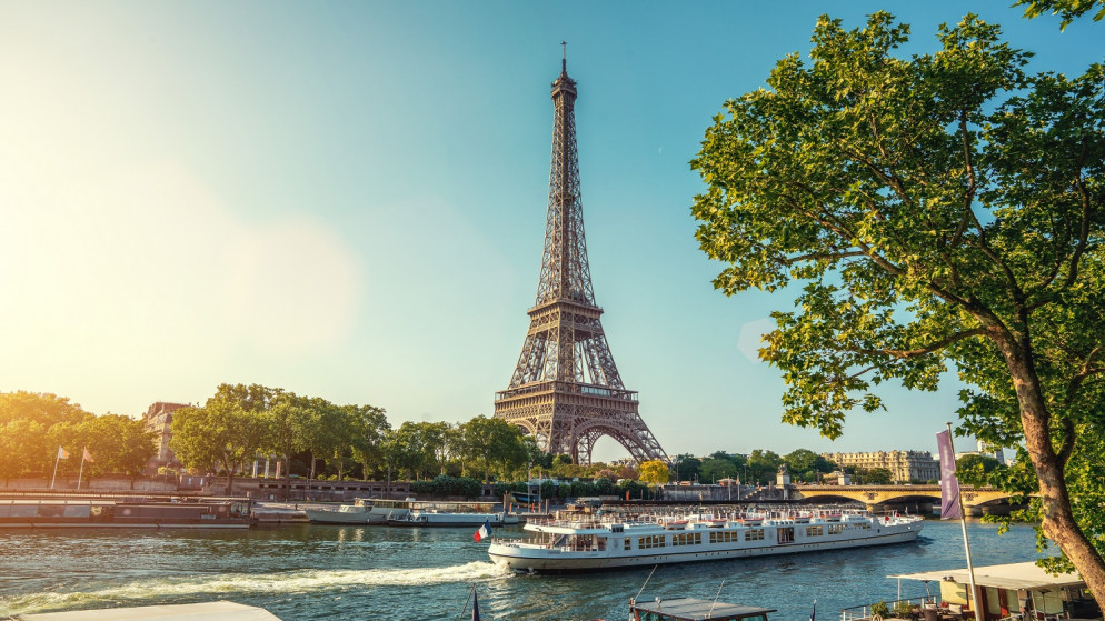 صورة إرشيفية لشارع باريس الصغير مع إطلالة على برج إيفل الشهير في يوم غائم ممطر مع بعض أشعة الشمس. (shutterstock)