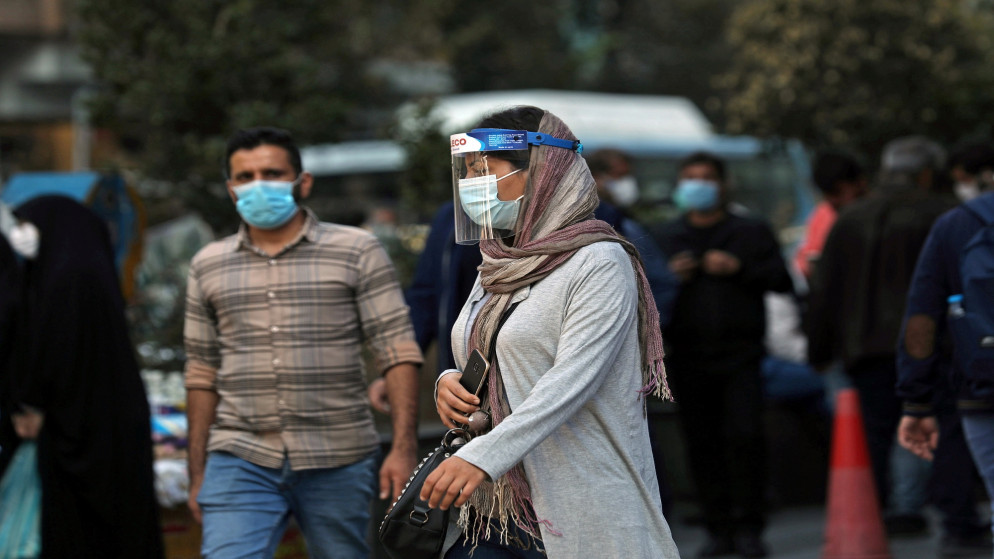 امرأة إيرانية ترتدي كمامات ودرعا واقيا للوجه، وسط تصاعد إصابات فيروس كورونا المستجد في طهران. 24/10/2020. (رويترز)
