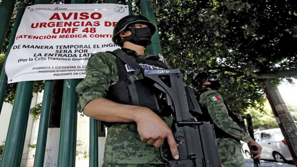 أعضاء الحرس الوطني، يقفون كجزء من التعزيز الأمني في المكسيك. (أ ف ب)
