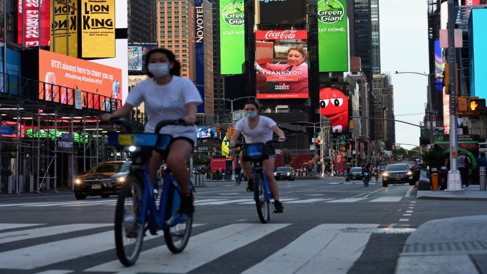 أشخاص يرتدون أقنعة وجه في مدينة نيويورك، وسط جائحة فيروس كورونا، 27 مايو 2020. (أ ف ب)