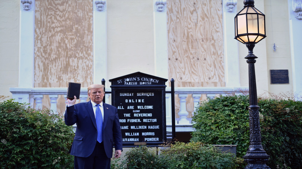 الرئيس الأمريكي دونالد ترامب يحمل كتابًا خارج كنيسة سانت جون الأسقفية عبر لافاييت بارك في واشنطن. 1 يونيو 2020. أ ف ب