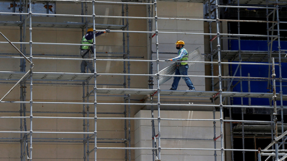 عمال بناء في مشروع إنشائي في عمّان بعد استئناف العمل في المشاريع الإنشائية في الأردن بعد توقفها بسبب انتشار فيروس كورونا. (رويترز)