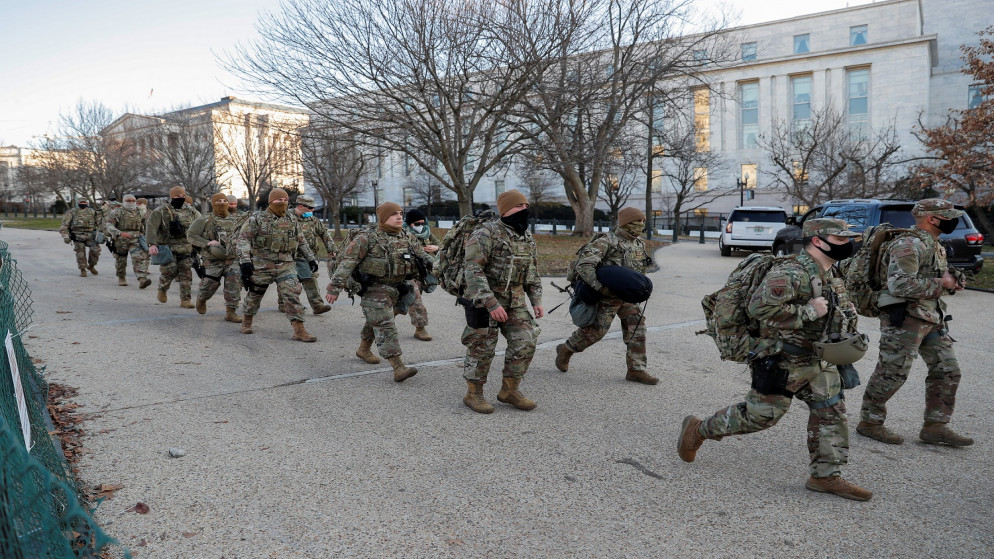 أعضاء الحرس الوطني الأميركي يسيرون بالقرب من مبنى الكابيتول في واشنطن. 13 كانون الثاني/ يناير 2021. (رويترز)