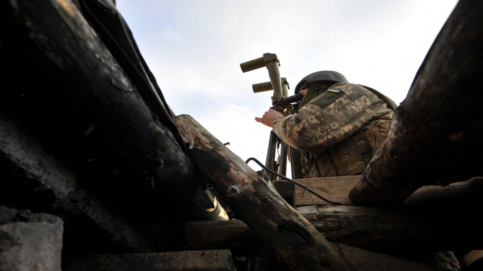 جندي أوكراني ينظر من منظار في موقع على خط المواجهة مع الانفصاليين المدعومين من روسيا بالقرب من قرية تالاكيفكا في منطقة دونيتسك، 24 تشرين الثاني/نوفمبر 2021. (أ ف ب)