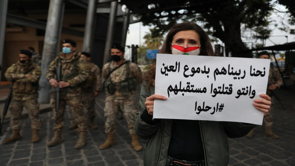 متظاهرة ترفع لافتة خلال مظاهرة أمهات في بيروت ضد الطبقة السياسية. (أ ف ب)