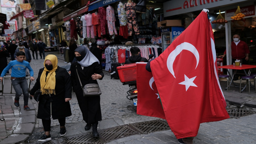 بائع متجول يبيع الأعلام الوطنية التركية في شارع محمود باشا ، منطقة تسوق شهيرة للطبقة الوسطى ، في اسطنبول بتركيا .22 مارس 2021. (رويترز / مراد سيزر)