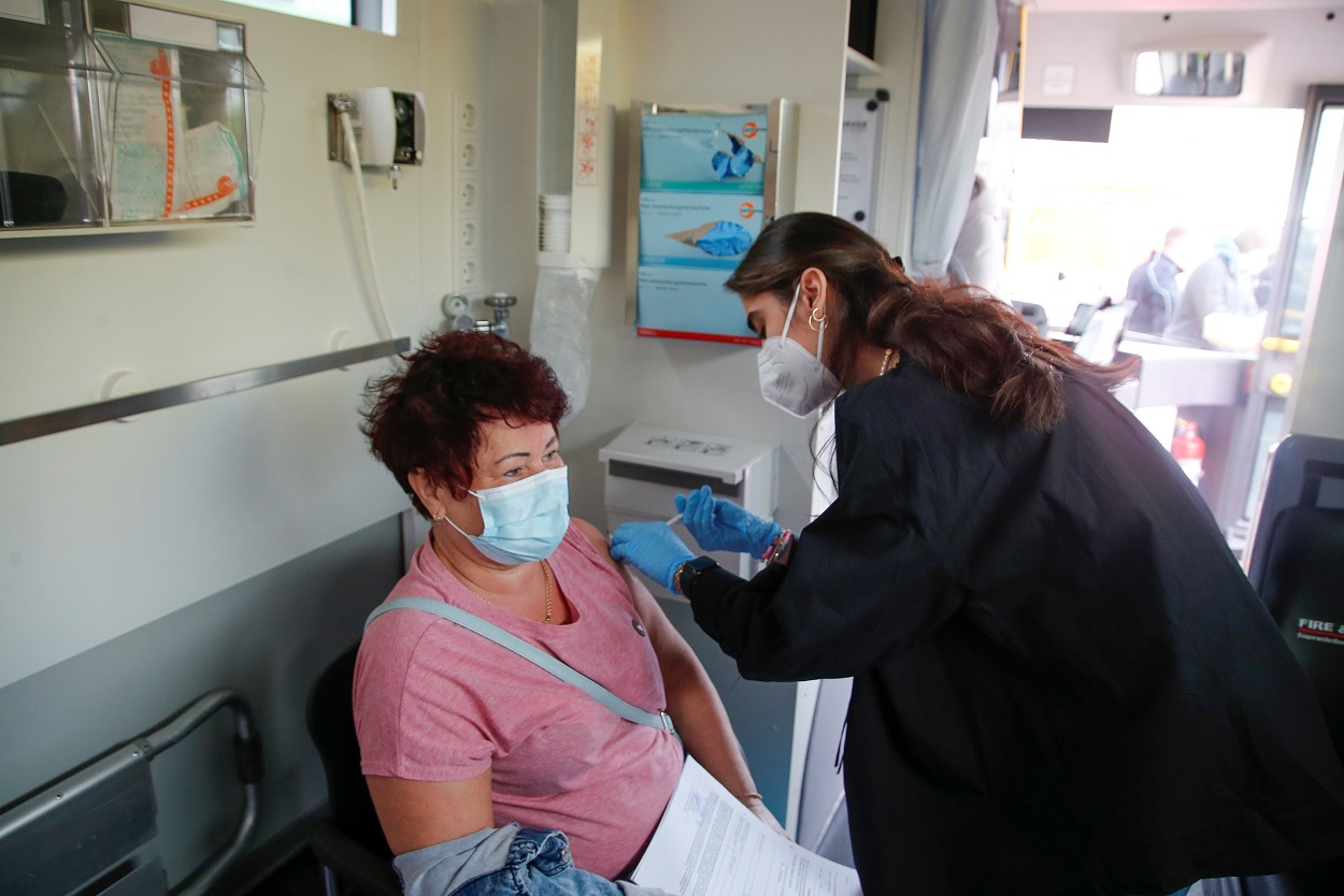 امرأة تتلقى جرعة من لقاح كورونا، في مركز تطعيم متنقل، مع استمرار انتشار الفيروس، في كولونيا بألمانيا، 3 مايو 2021. (رويترز)
