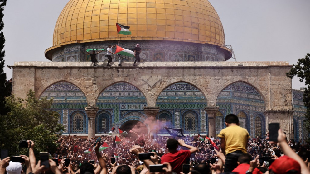 فلسطينيون يرفعون العلم الفلسطيني في الحرم  القدسي الشريف. 21 أيار/مايو 2021. (أ ف ب)