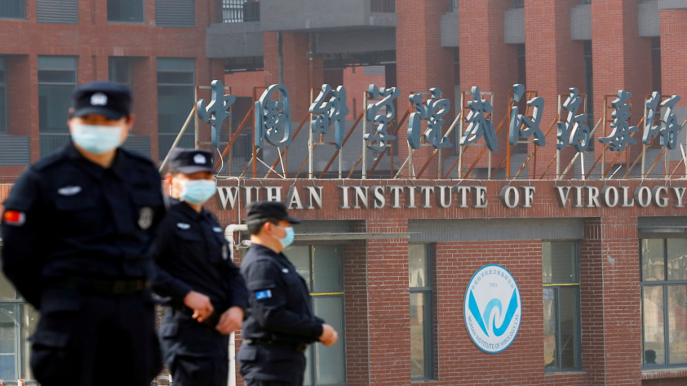 أفراد أمن يرتدون كمامات ويقفون خارج معهد ووهان لعلم الفيروسات، في ووهان، مقاطعة هوبي، الصين، 3 شباط/فبراير 2021. (رويترز)