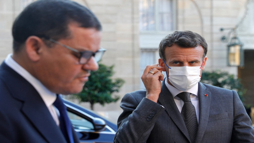 الرئيس الفرنسي إيمانويل ماكرون (يمين) يلقي نظرة على رئيس الوزراء الليبي المؤقت عبد الحميد دبيبة (يسار) وهو يلقي كلمة في قصر الإليزيه في باريس، 1 حزيران/يونيو 2021. (أ ف ب)