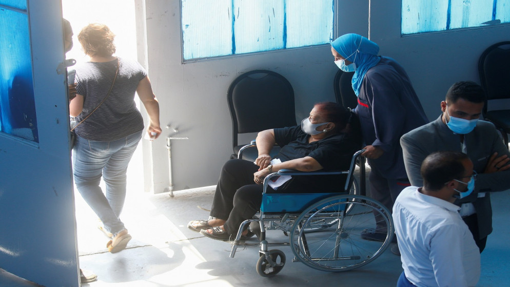 امرأة مسنة ترتدي كمامة واقية للوجه ضد كورونا، تغادر بعد تلقيها لقاحًا ضد الفيروس، في مركز القاهرة الدولي للمعارض، مصر، 5 يونيو/حزيران 2021. (رويترز)