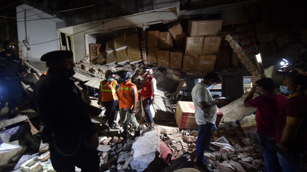 رجال الإطفاء يتفقدون الموقع بعد انفجار غاز في حي وسط العاصمة دكا أسفر عن مقتل 7 أشخاص وإصابة نحو 50 آخرين، 27 يونيو 2021. (أ ف ب)