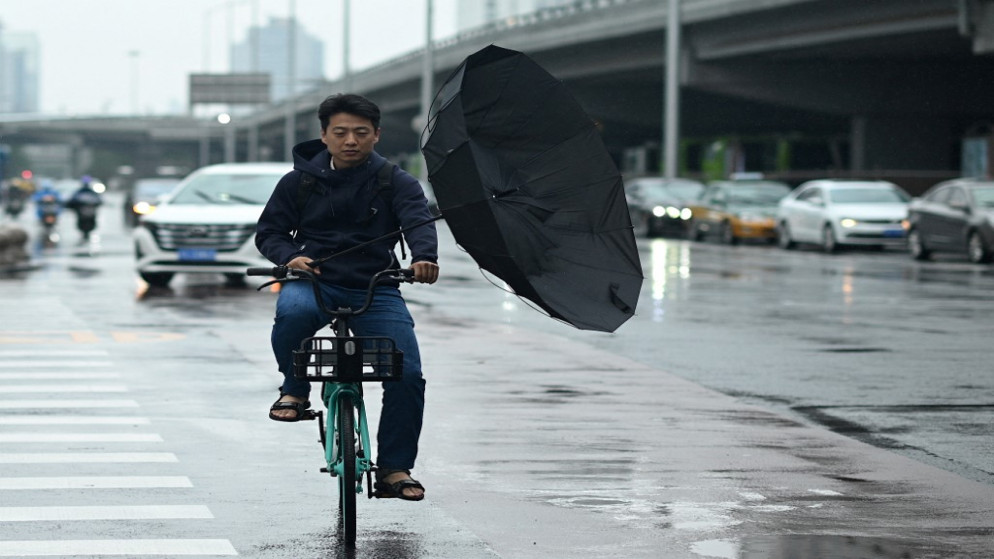 رجل يتنقل في أحد شوارع بكين .12 يوليو 2021.(أ ف ب)