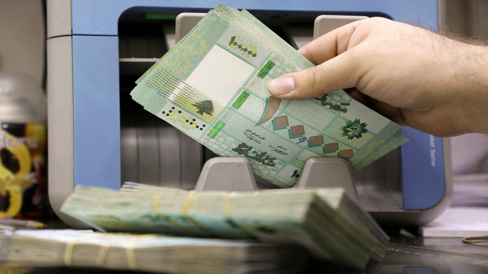 رجل يعد أوراق نقدية بالليرة اللبنانية في متجر لصرافة العملات في بيروت. 05/01/2022. (محمد أزاكير / رويترز)
