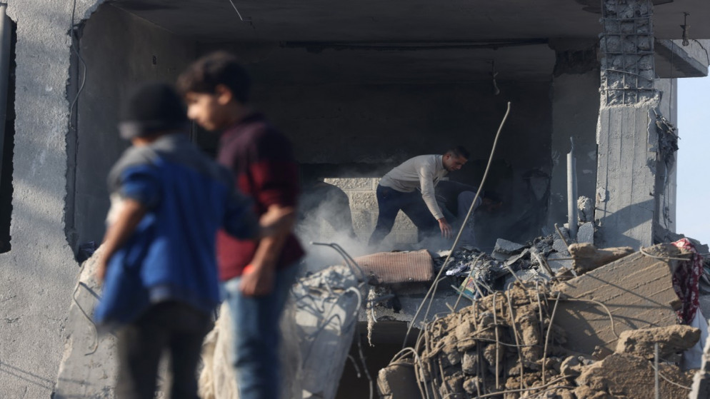 رجل فلسطيني يتفقد الأضرار التي لحقت بمبنى سكني في رفح جنوب قطاع غزة، جراء العدوان الإسرائيلي. 4 ديسمبر، 2023. (أ ف ب)