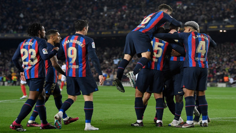 لاعبو برشلونة خلال احتفالهم في الفوز على إِشبيلية وابتعادهم في صدارة الدوري الإسباني لكرة القدم. (أ ف ب)