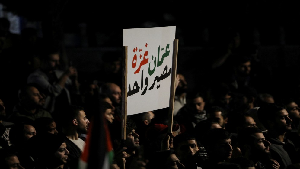 متظاهرون يحملون لافتة خلال تظاهرة قرب السفارة الإسرائيلية في عمان، 28 آذار/مارس 2024. (رويترز)
