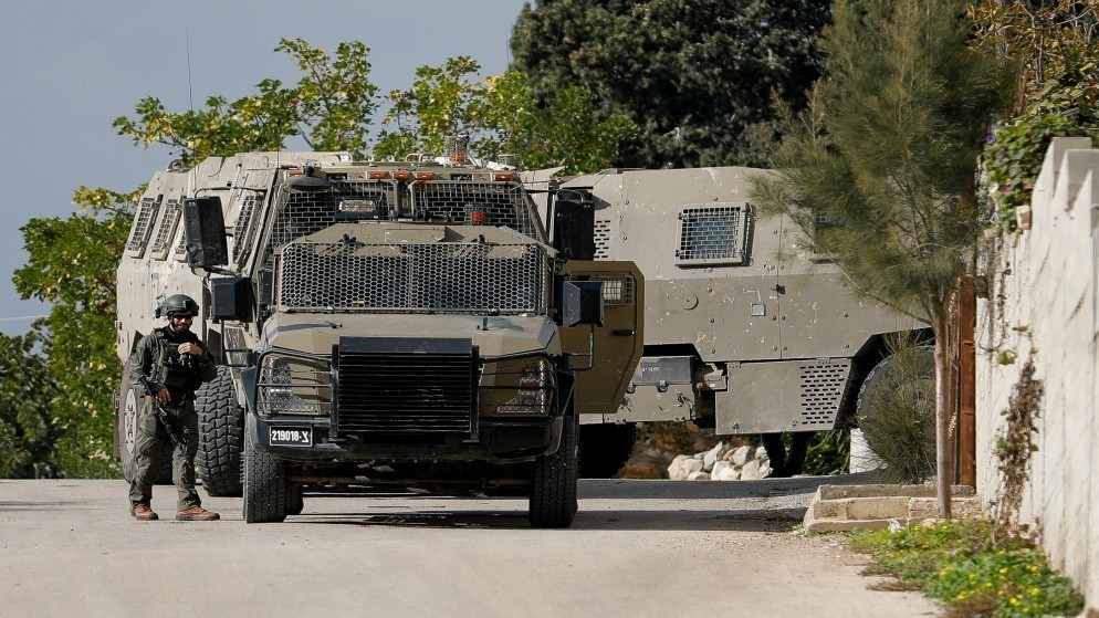 جندي إسرائيلي بجانب مركبة عسكرية خلال اقتحام سابق لجنين. (رويترز)
