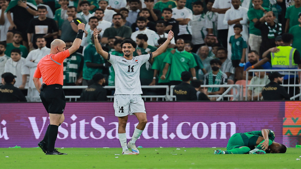 الحكم الأردني أدهم مخادمة يشهر البطاقة الصفراء في وجه اللاعب العراقي زيدان إقبال خلال مباراة السعودية والعراق ضمن منافسات الملحق الآسيوي المؤهل إلى كأس العالم 2026. (أ ف ب)