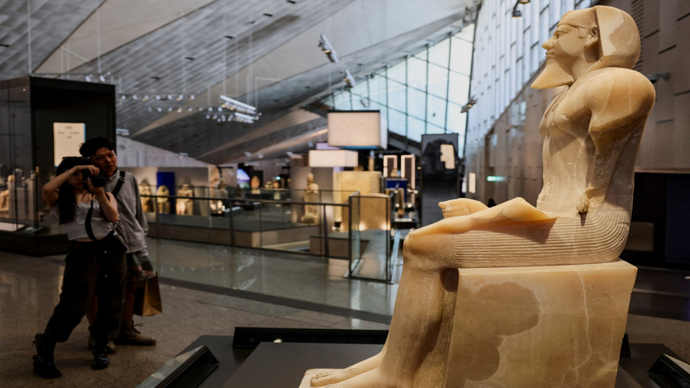 سياح يشاهدون معروضات المتحف المصري الكبير في الجيزة، مصر، 2 حزيران 2025.(رويترز)