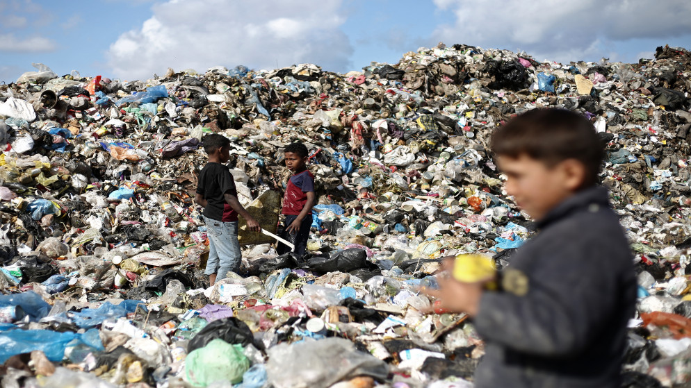 أطفال فلسطينيون نازحون بالقرب من مكب نفايات بمخيم البريج للاجئين في وسط قطاع غزة، 10 نسيان 2025. (أ ف ب)