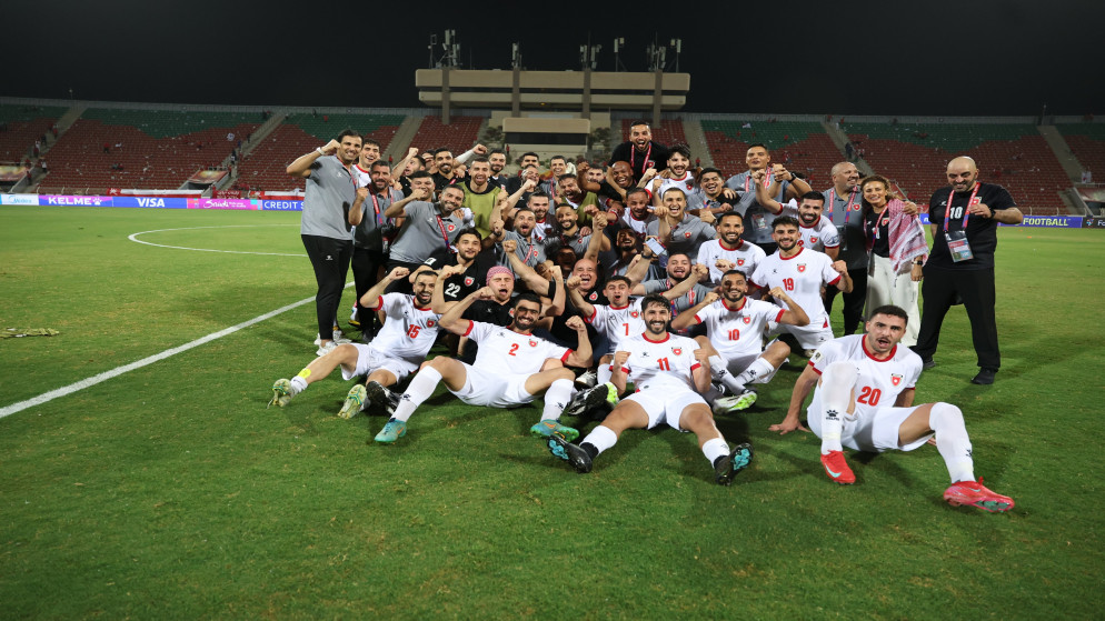 لاعبو المنتخب الوطني لكرة القدم يحتفلون بعد فوزهم على المنتخب العُماني.
