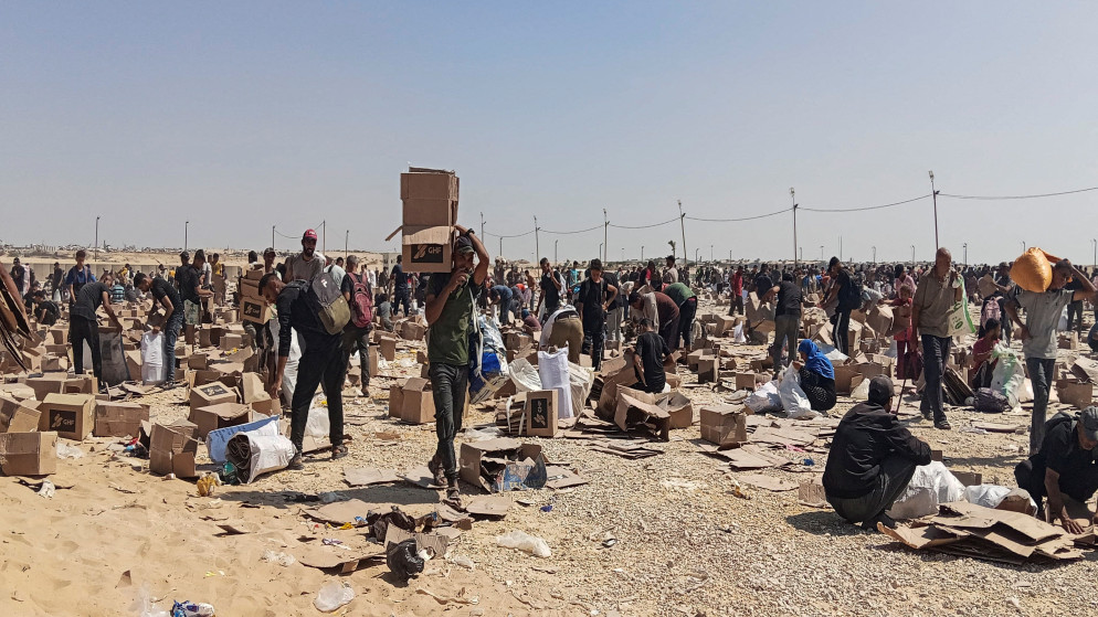 فلسطينيون يتجمعون لجمع ما تبقى من إمدادات الإغاثة من مركز توزيع مؤسسة غزة الإنسانية في رفح جنوبي قطاع غزة. 5 حزيران 2025. (رويترز)