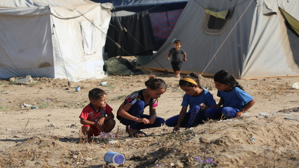 أطفال فلسطينيون يجلسون على أطراف المأساة في غزة، 1 أيار 2025. (أ ف ب)