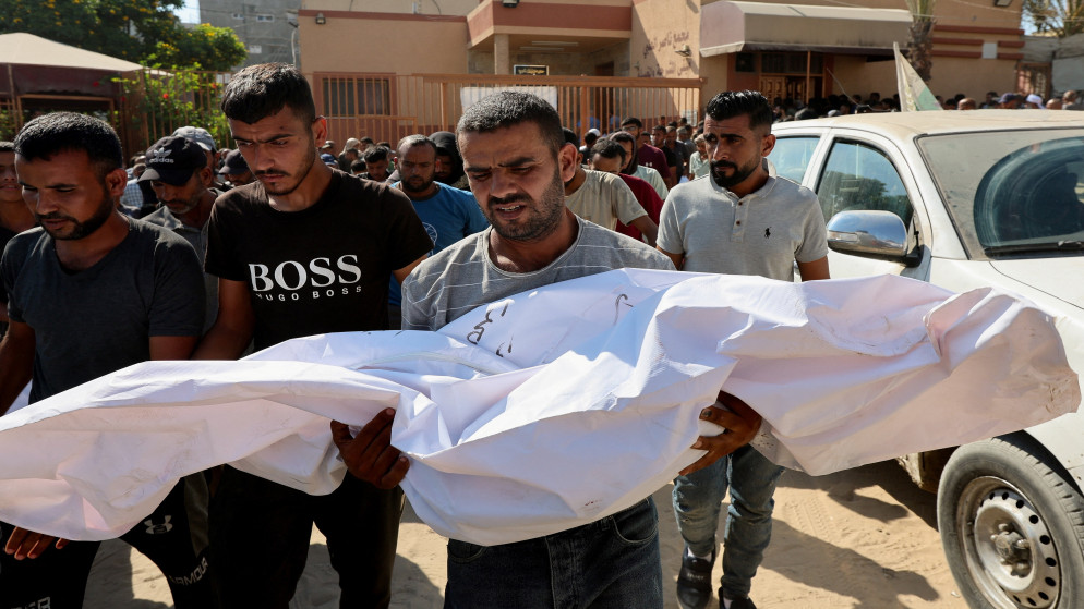 فلسطيني يحمل جثمان شهيد قُتل بنيران قوات الاحتلال الإسرائيلي أثناء محاولته تلقي المساعدة في خان يونس جنوب قطاع غزة. 27 تموز 2025 (رويترز)