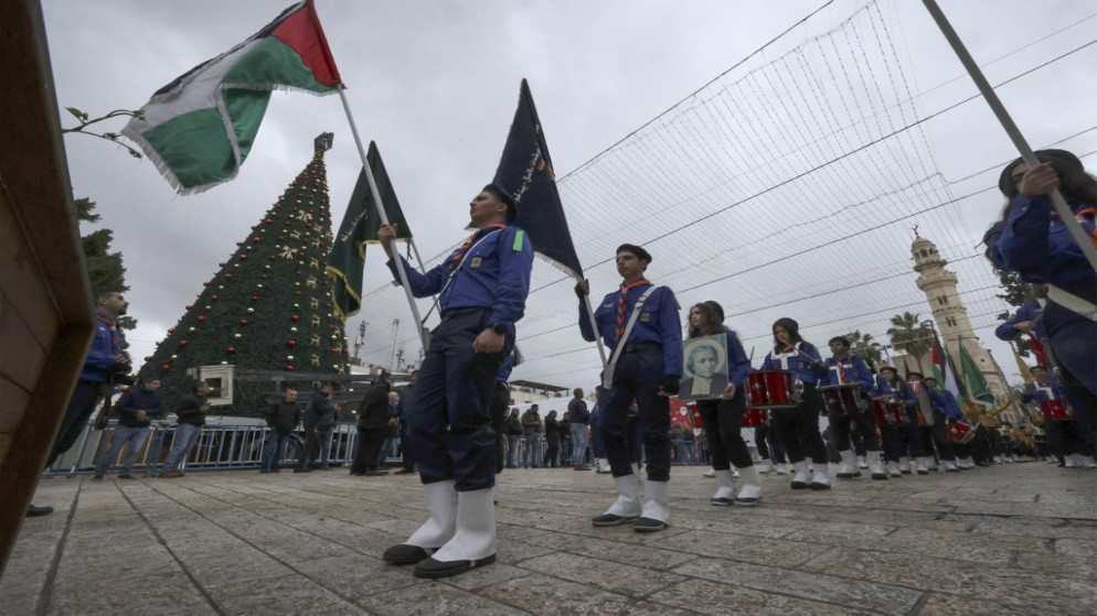 مسيرة كشافة فلسطينية خلال احتفال في كنيسة المهد لإطلاق بداية موسم الكريسماس، في مدينة بيت لحم بالضفة الغربية المحتلة ، 26 تشرين الثاني 2022. (أ ف ب)
