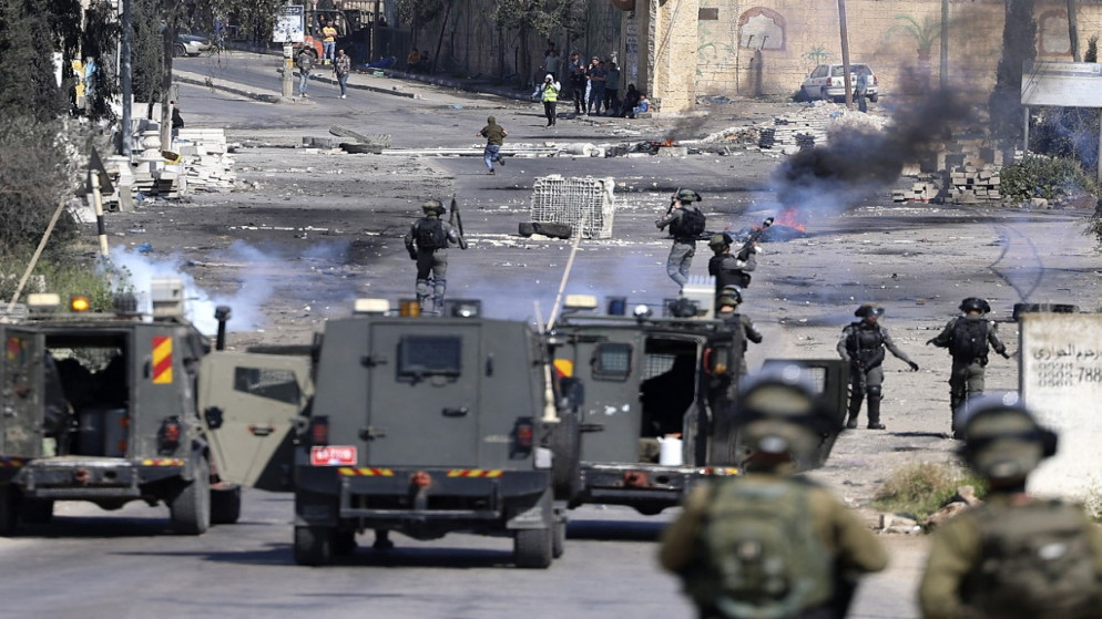 قوات الاحتلال الإسرائيلي تطلق الغاز المسيل للدموع خلال مواجهات مع متظاهرين فلسطينيين في أعقاب تظاهرة على الشارع الرئيسي في قرية بيتا بالضفة الغربية المحتلة . 15 أبريل / نيسان 2022.(أ ف ب)