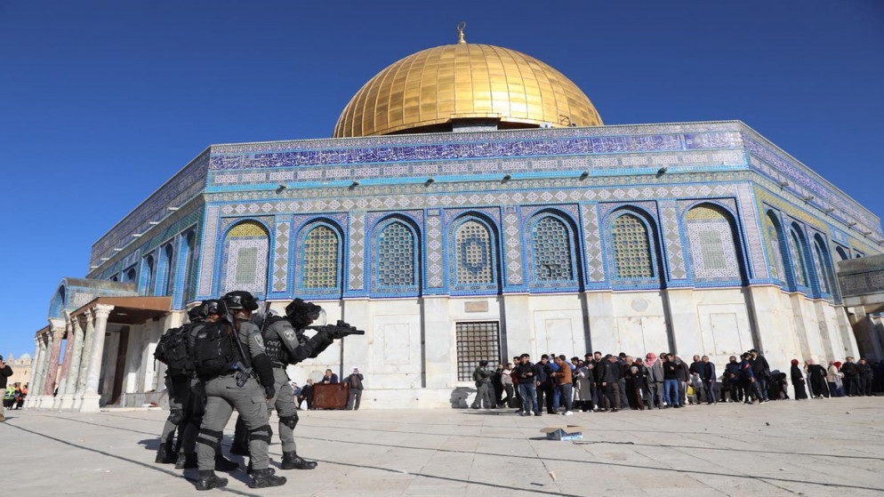 شرطي تابع للاحتلال الإسرائيلي يوجه بندقيته نحو الفلسطينيين في المسجد الأقصى 15/4/2022 (وفا)