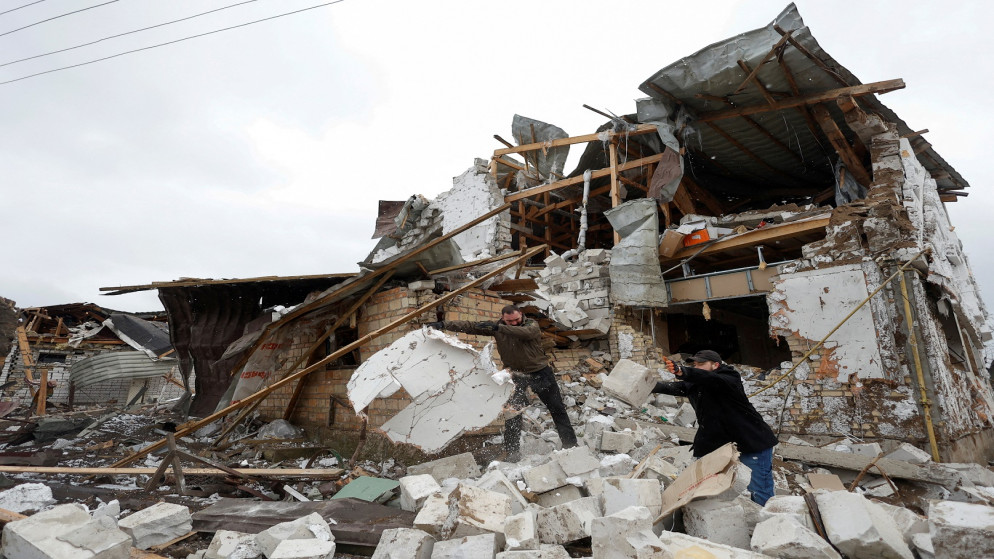 سكان محليون يزيلون حطام منزل لجارهم تضرر من غارة عسكرية روسية، في خارج كييف، أوكرانيا، 26 كانون الثاني/ يناير 2023. (رويترز)